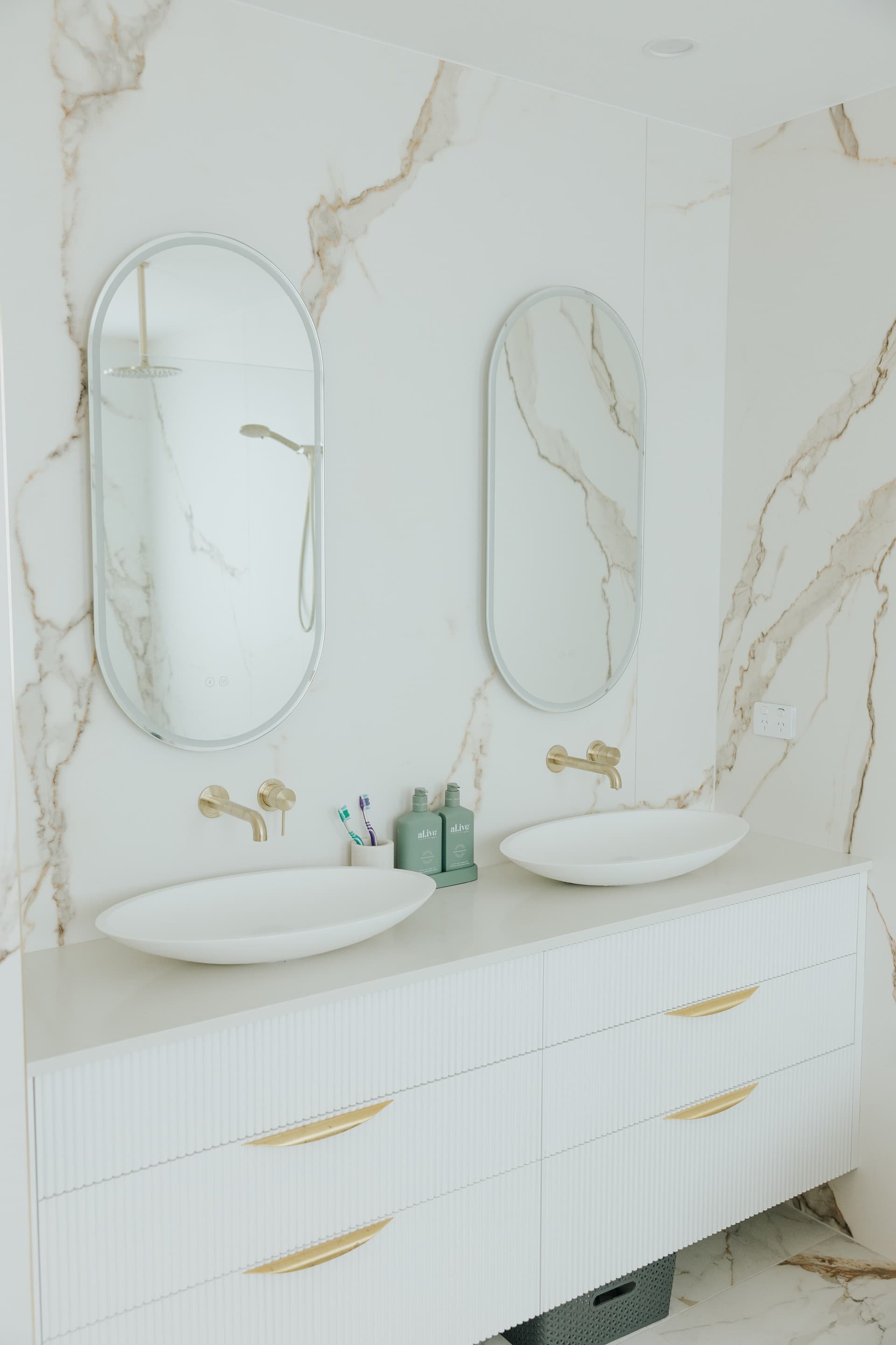 KBLCO bathroom renovation, Sydney. Portrait wet area with stone vanity.
