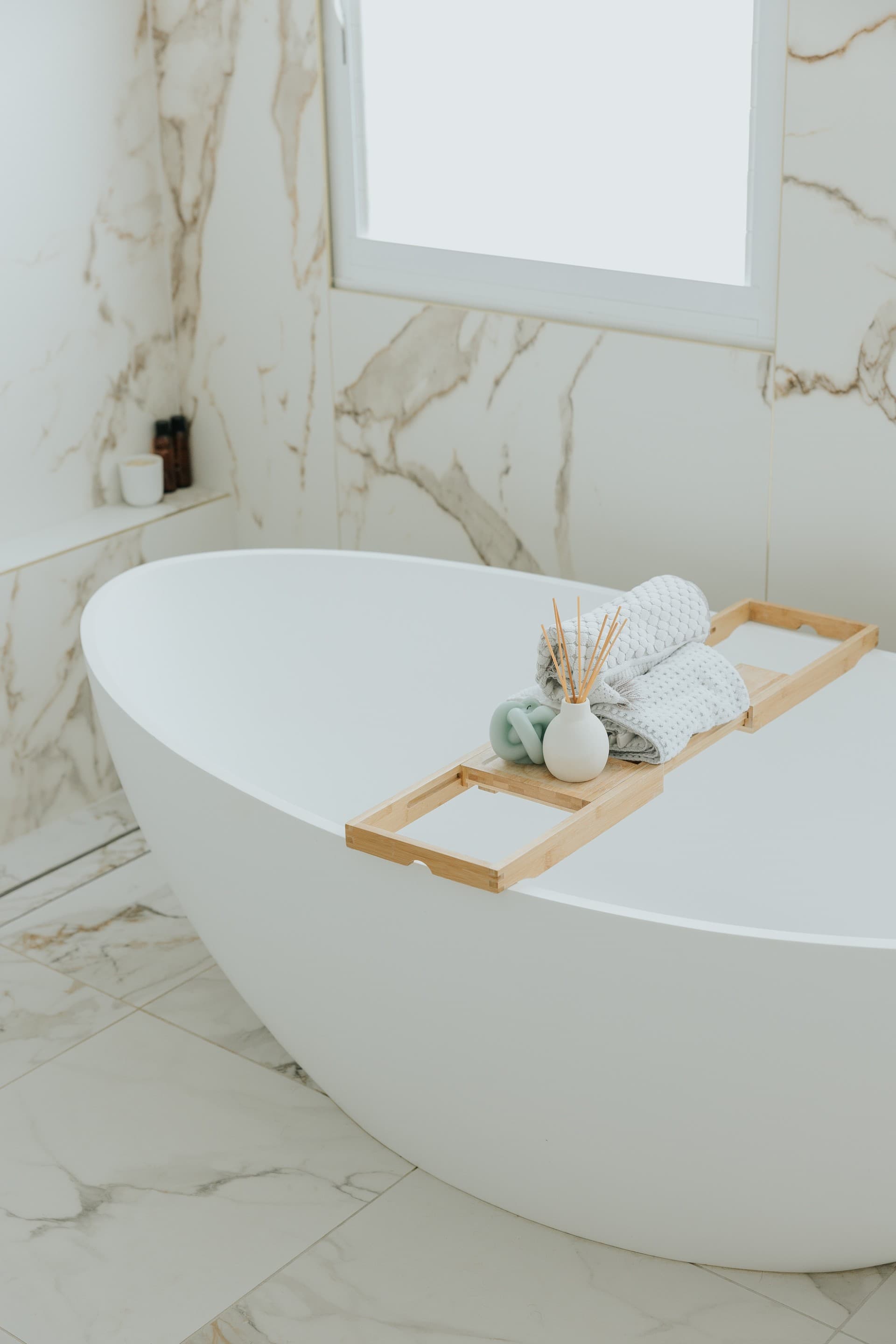KBLCO bathroom renovation, Sydney. Bath tray and towels on a freestanding bath.