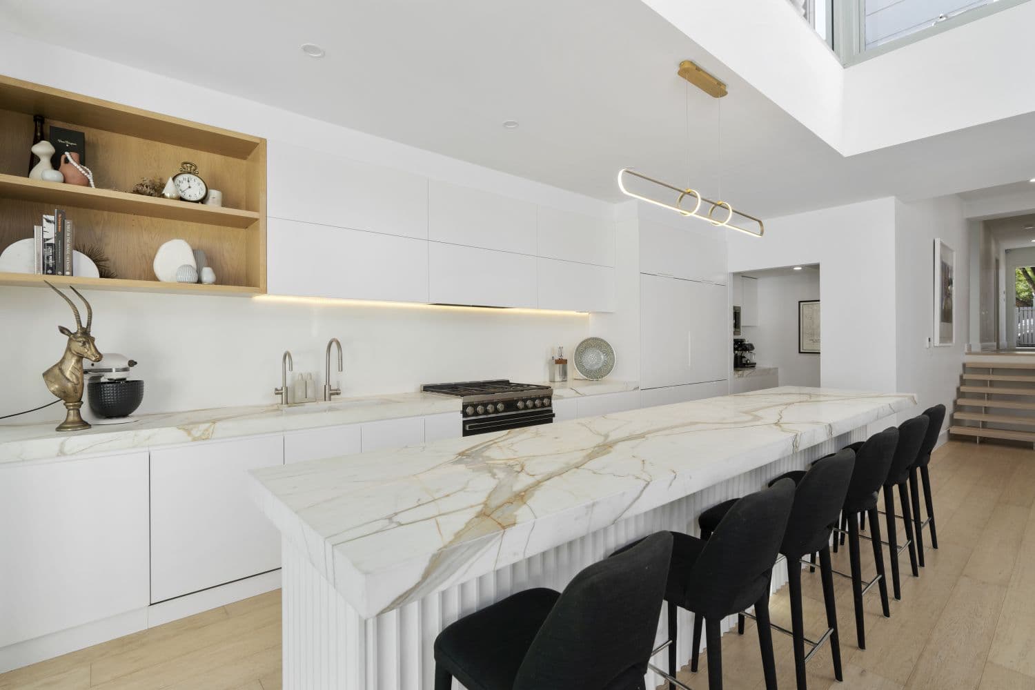 KBLCO kitchen renovation, Sydney. Calacatta marble waterfall island and brass linear pendant.