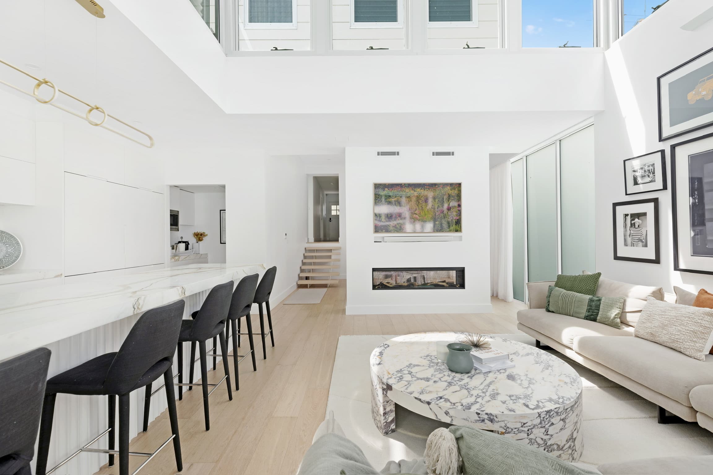 KBLCO living room, Sydney. Bright white living with a linen sofa and integrated media wall.