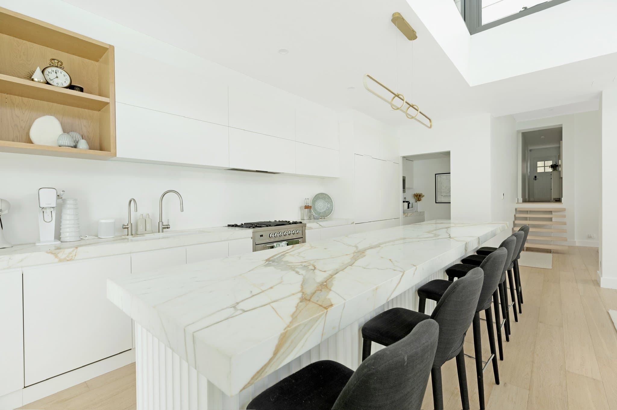 KBLCO kitchen renovation, Sydney. Marble island and integrated joinery in a white palette.