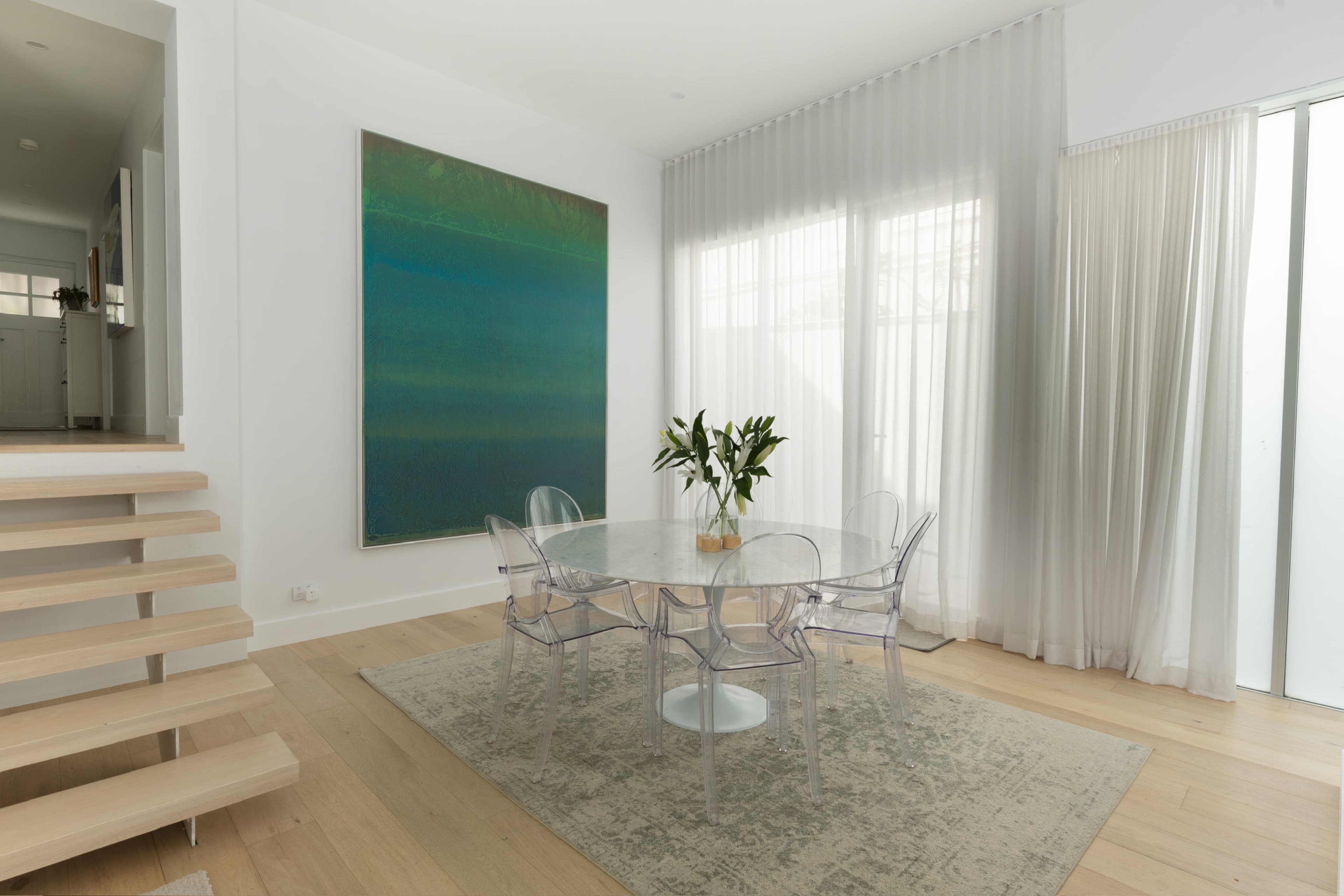 KBLCO living room, Sydney. Marble dining table beside the floating oak stair.