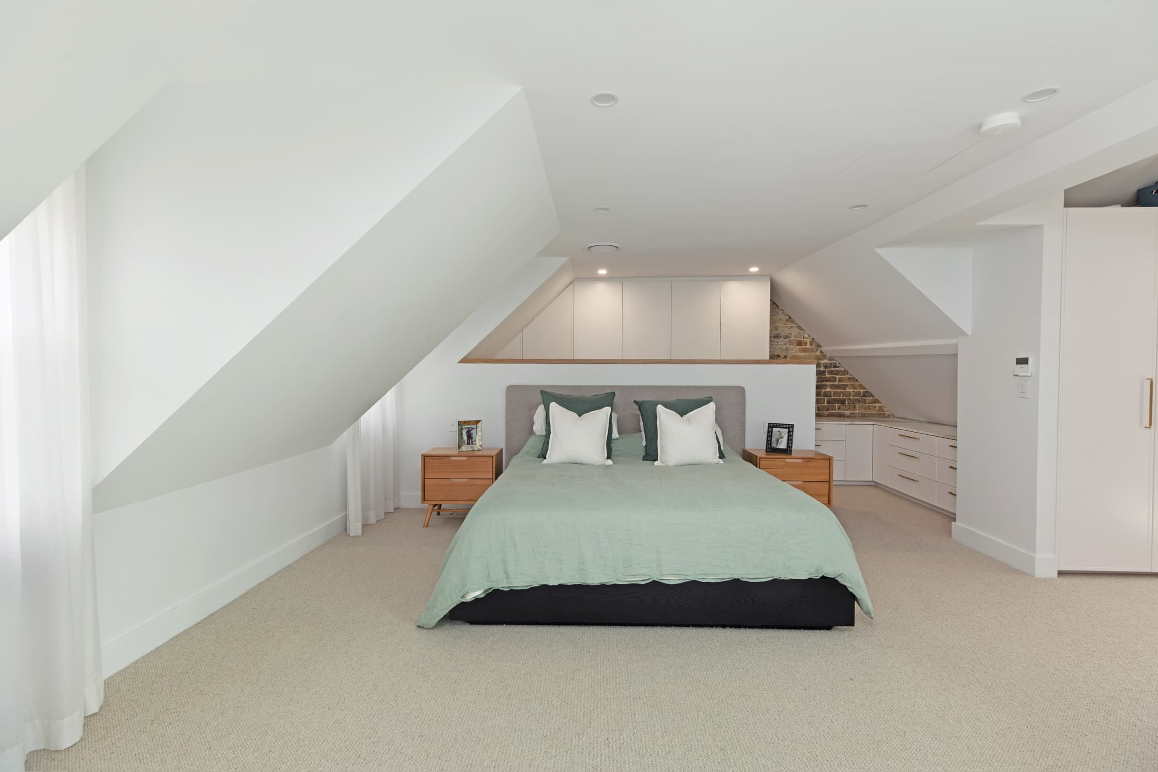 KBLCO bedroom renovation, Sydney. Loft retreat with an exposed brick chimney.