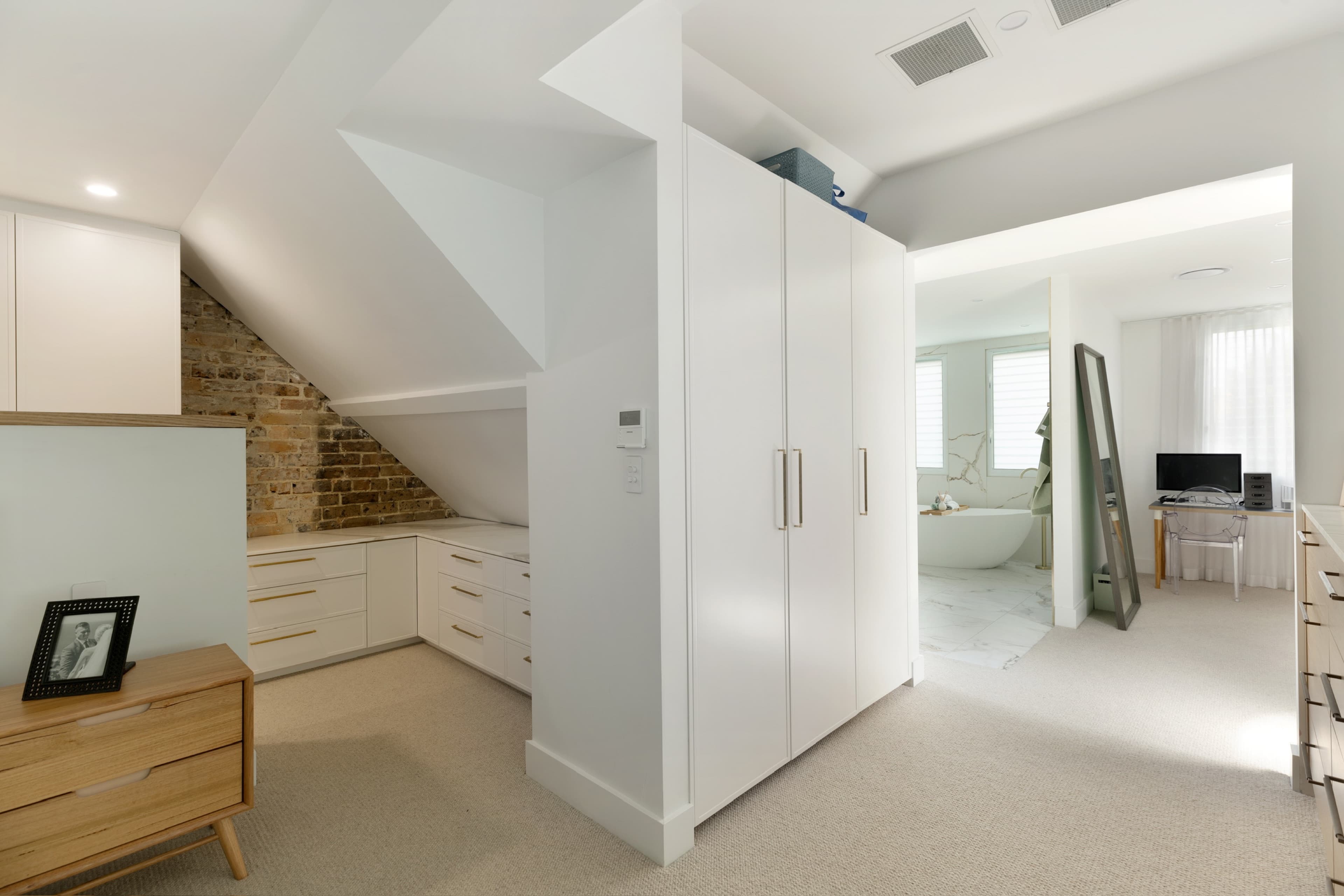 KBLCO bedroom renovation, Sydney. Under-eave wardrobe joinery in the loft dressing zone.