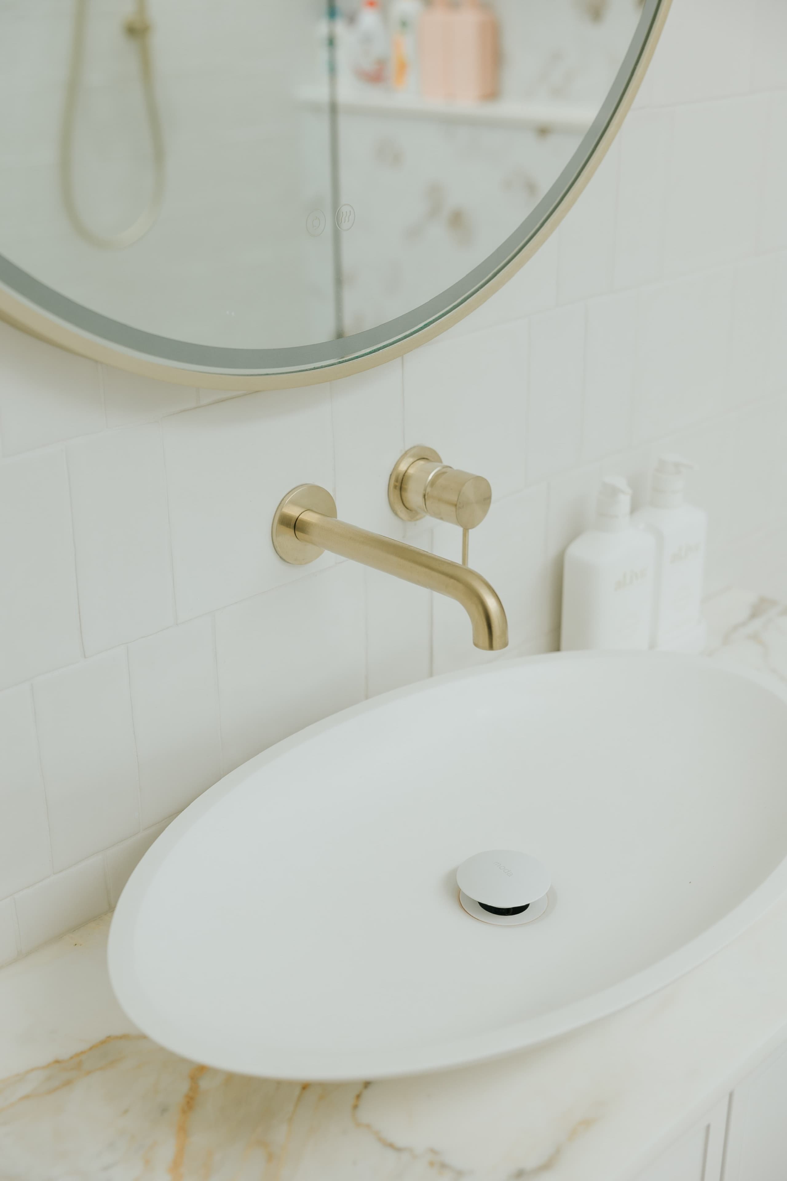 KBLCO bathroom renovation, Sydney. Brass tapware on a marble bench.