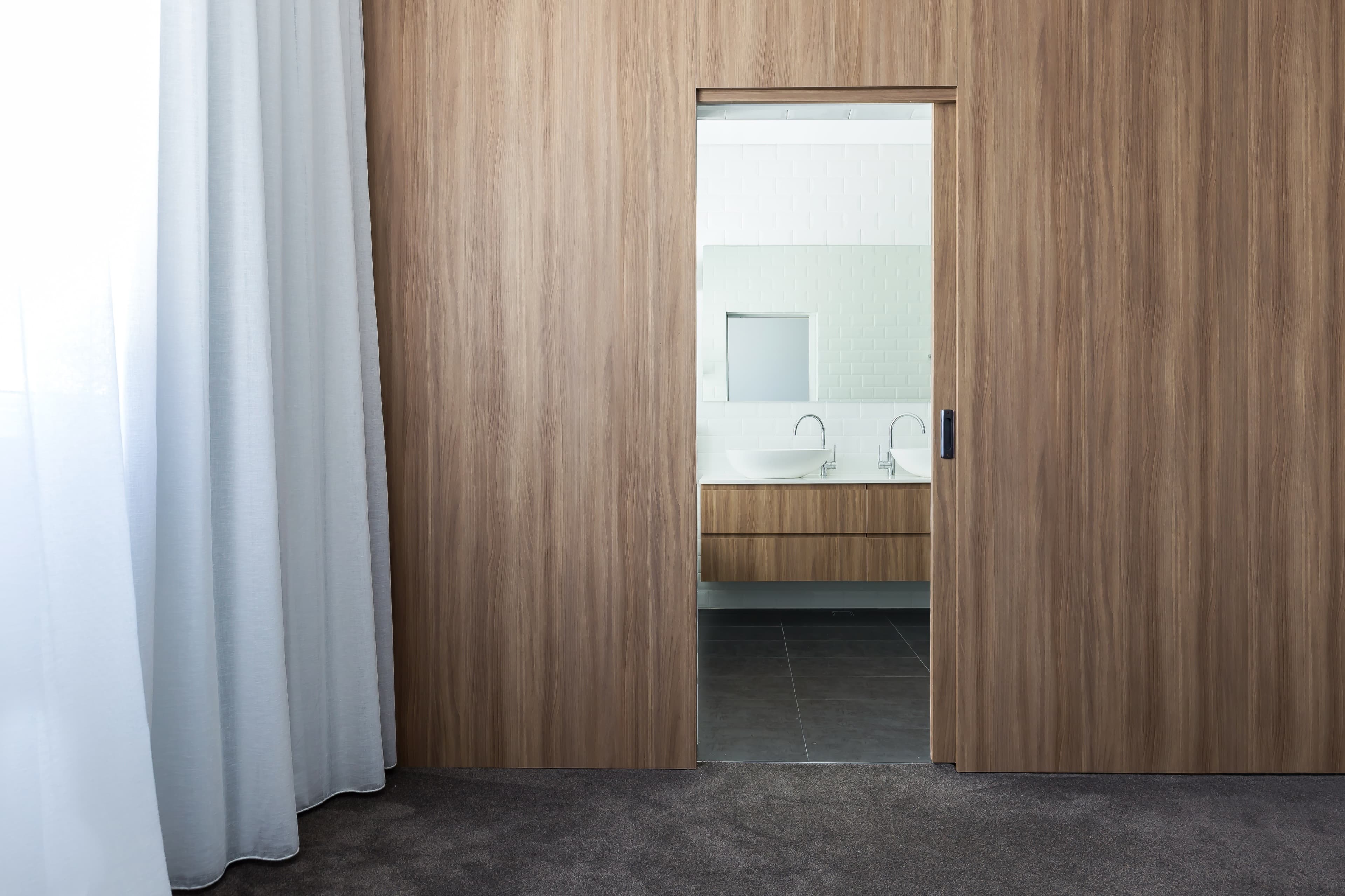 KBLCO bathroom renovation, Sydney. Timber joinery threshold to a considered ensuite.