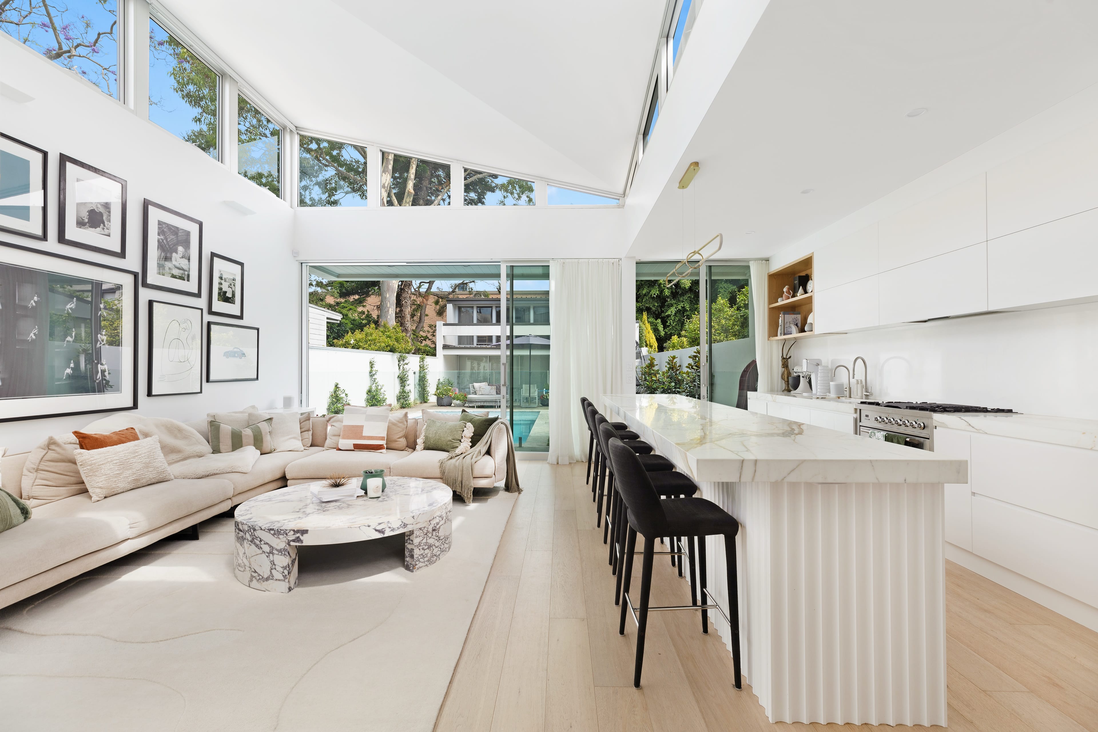 An open-plan living and kitchen the studio has designed, beneath a vaulted skylight.