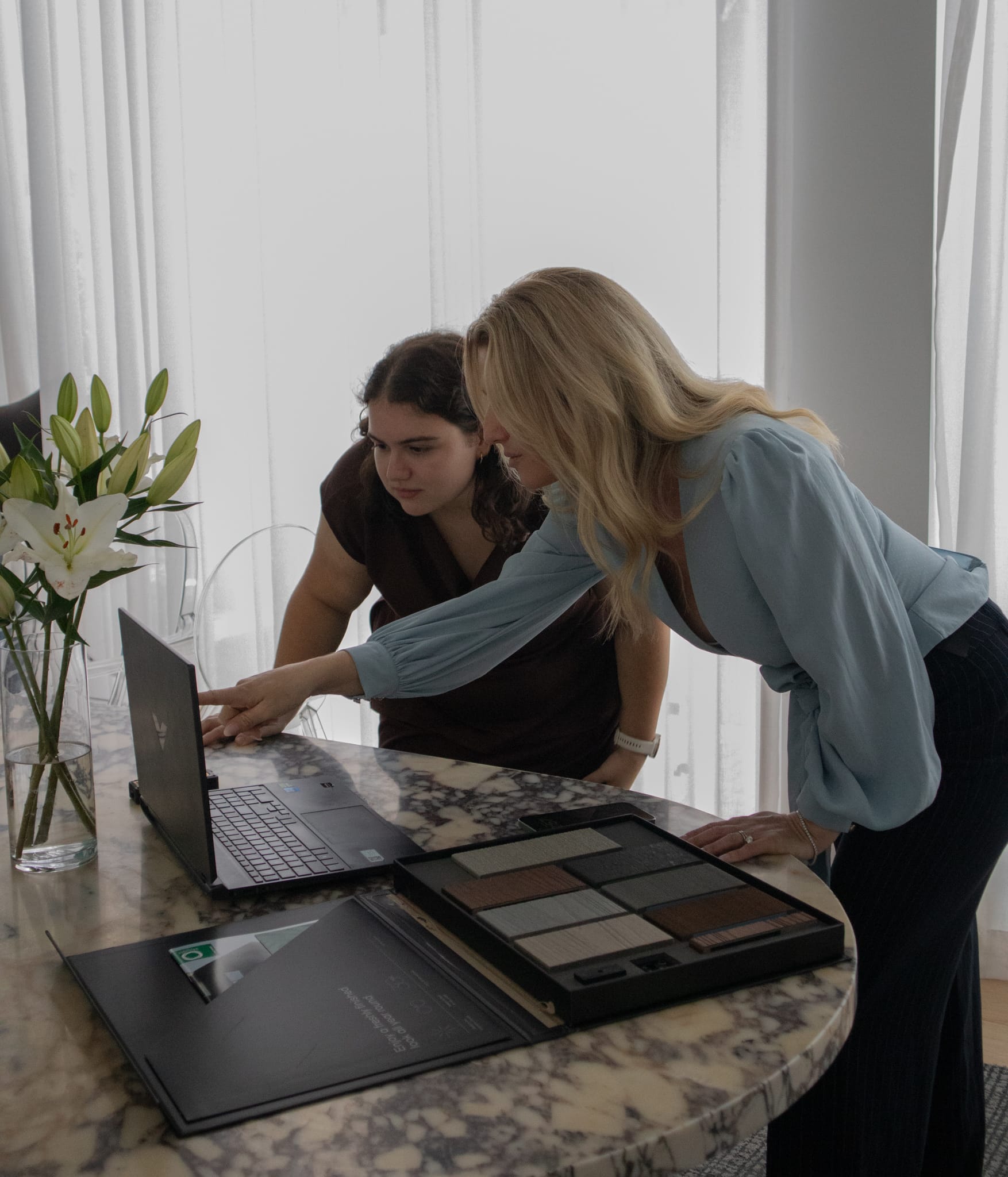The studio working through the design together at a laptop.