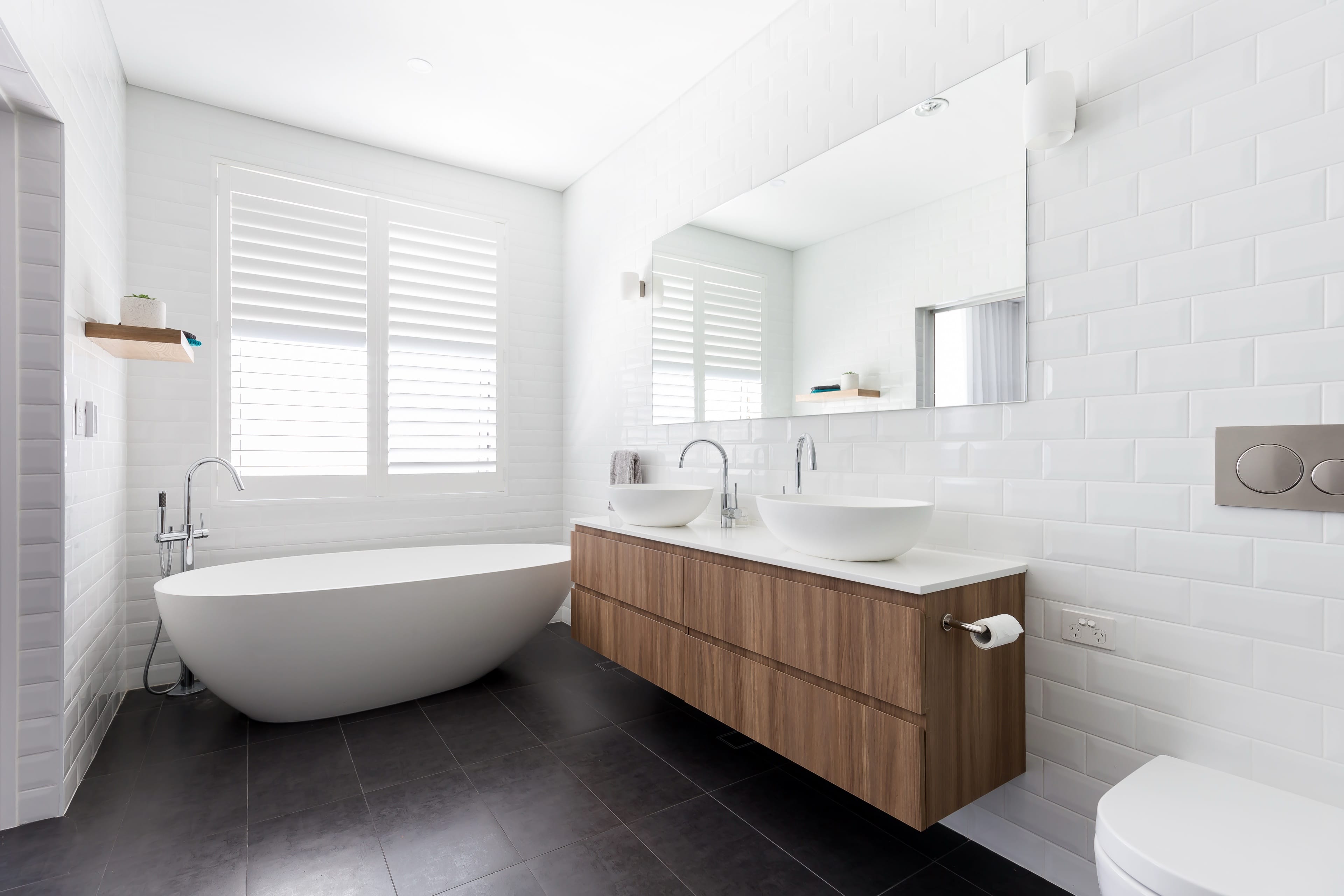 Johnston bathroom with a freestanding bath and timber vanity.