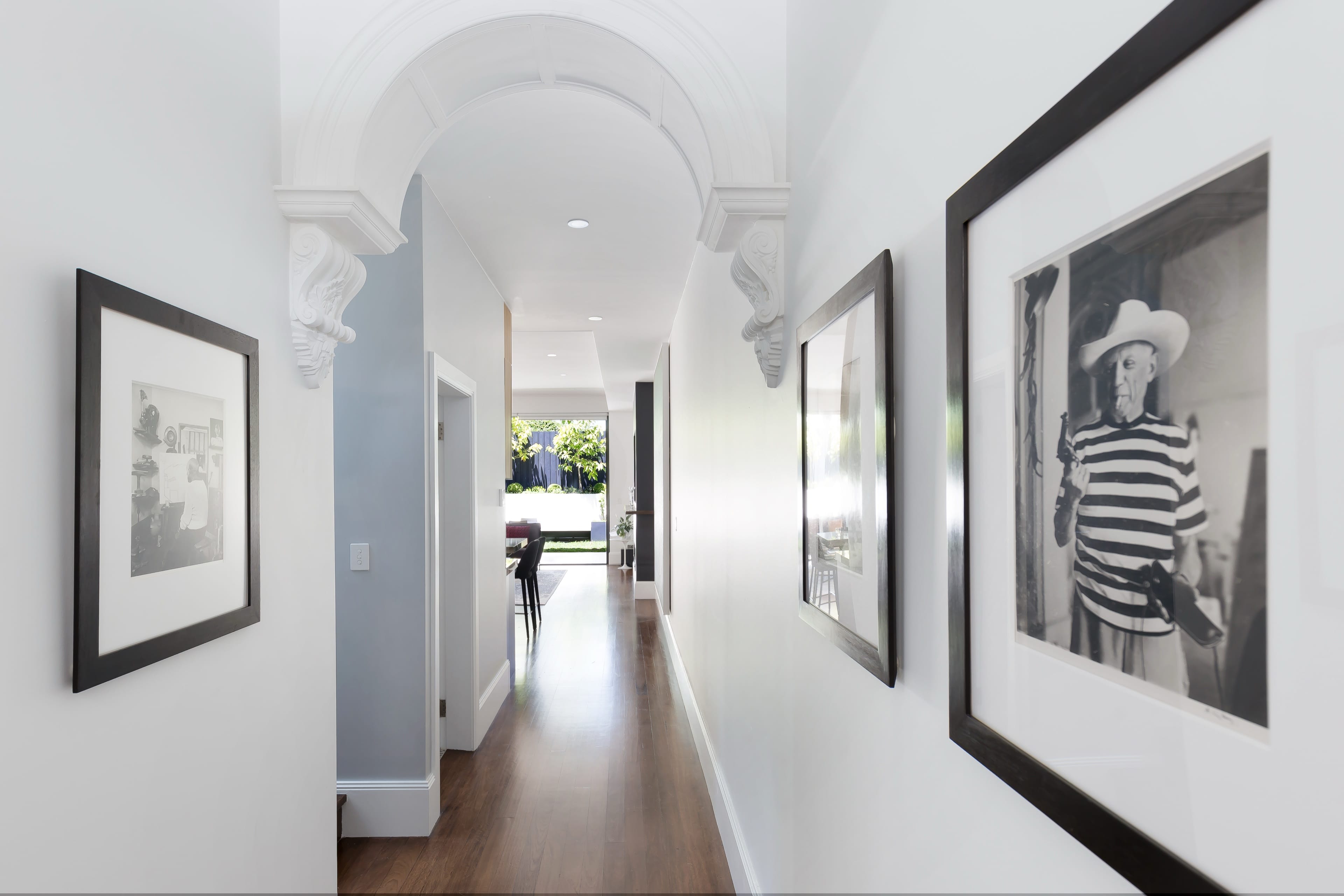Johnston arched hallway with a framed gallery wall.