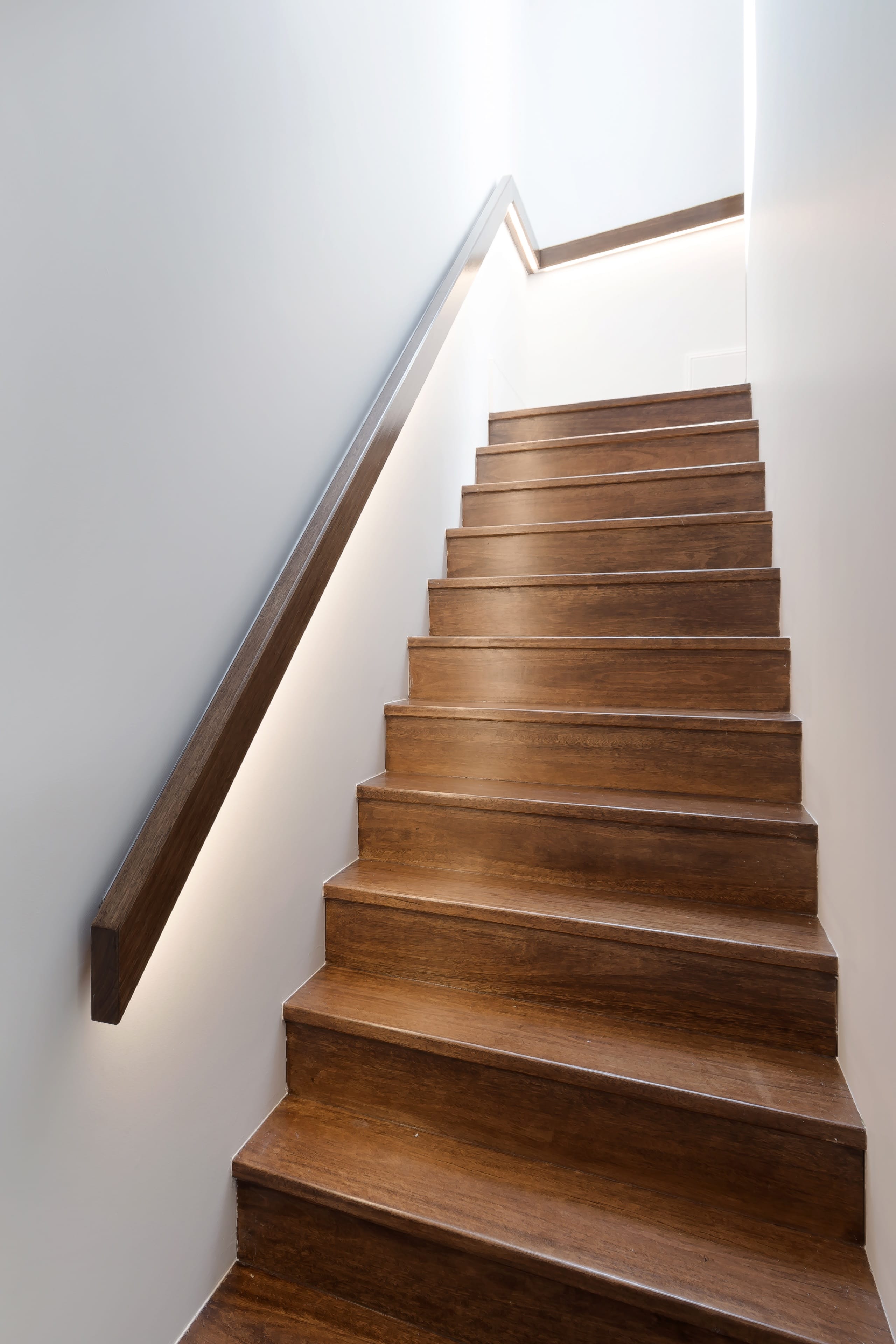 Johnston timber staircase with a recessed handrail light.