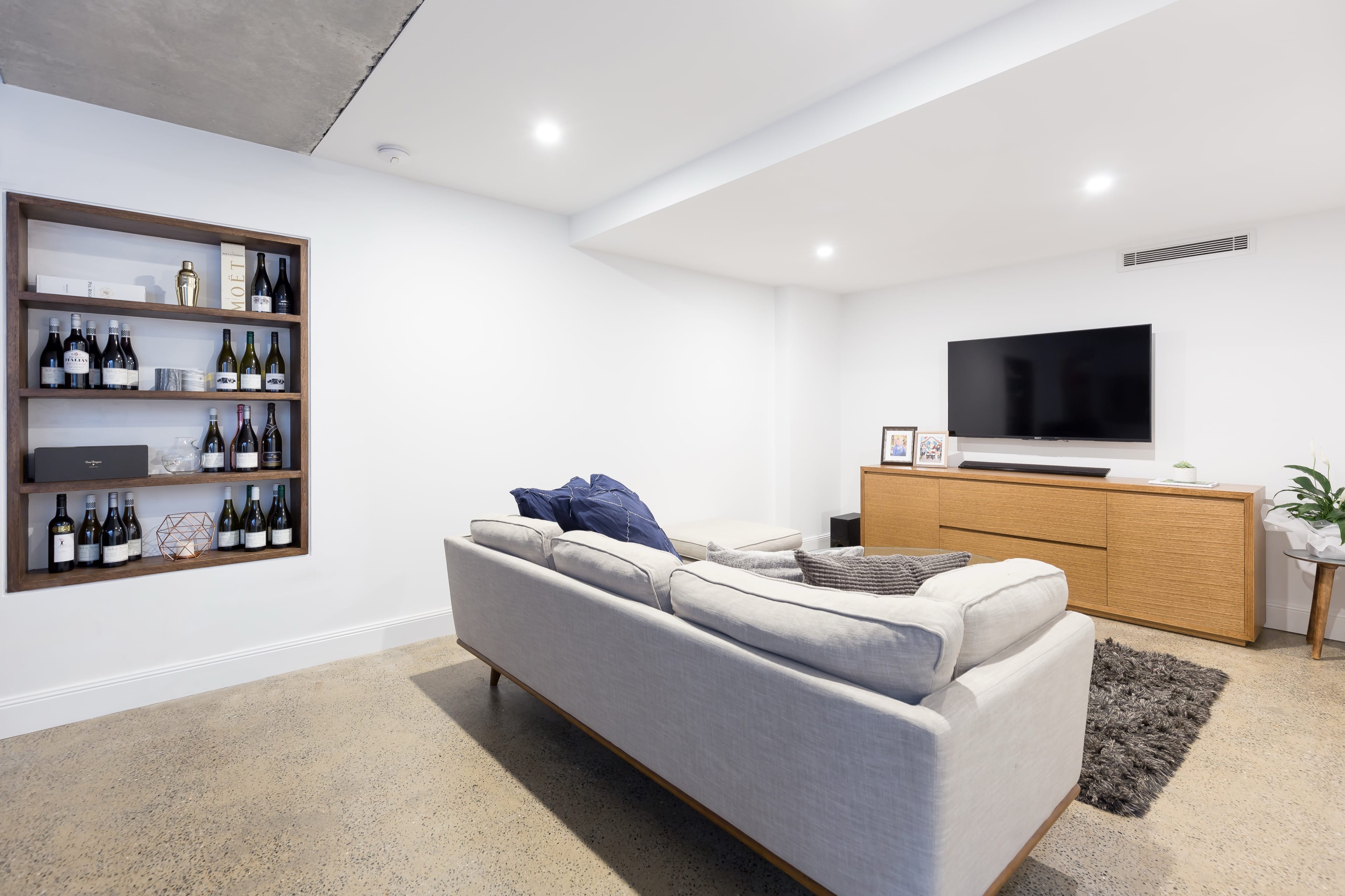 Johnston living zone with built-in shelving and a media wall.